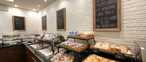A buffet area with various food items and a chalkboard with inspirational messages.