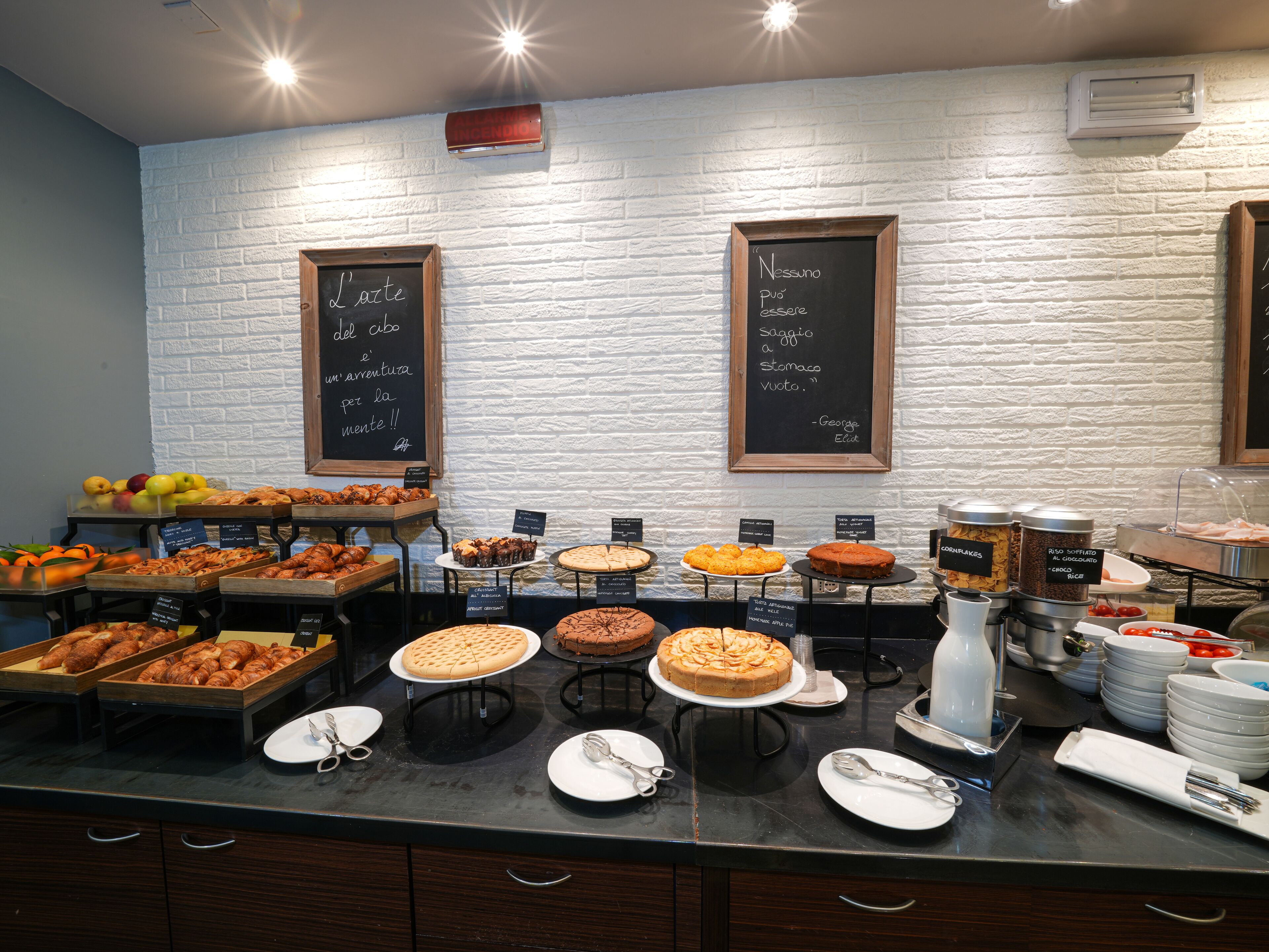 A buffet with various food items and a chalkboard menu.