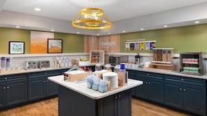 A modern kitchen with a central island, a microwave, and a coffee station. - Spark by Hilton Chincoteague Island (Chincoteague)