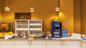 A breakfast bar with a coffee machine, a fruit bowl, and a variety of breakfast items.