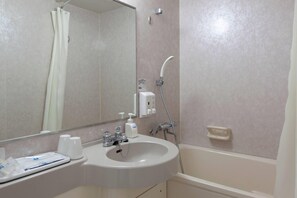 A bathroom with a sink, mirror, shower, and toiletries. - Comfort Hotel Tendo (Tendo)