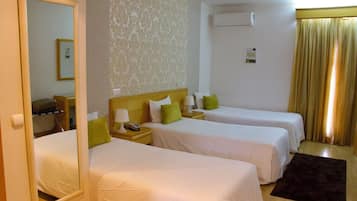 Standard Triple Room | Minibar, desk, laptop workspace, blackout drapes