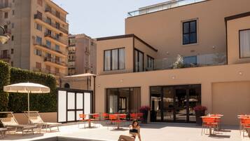 Outdoor pool, open 9:30 AM to 8:00 PM, pool umbrellas, pool loungers