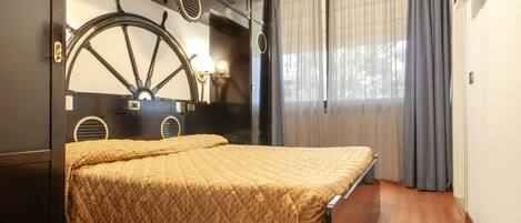 A room with a bed, a large wheel-like headboard, and a window with curtains.