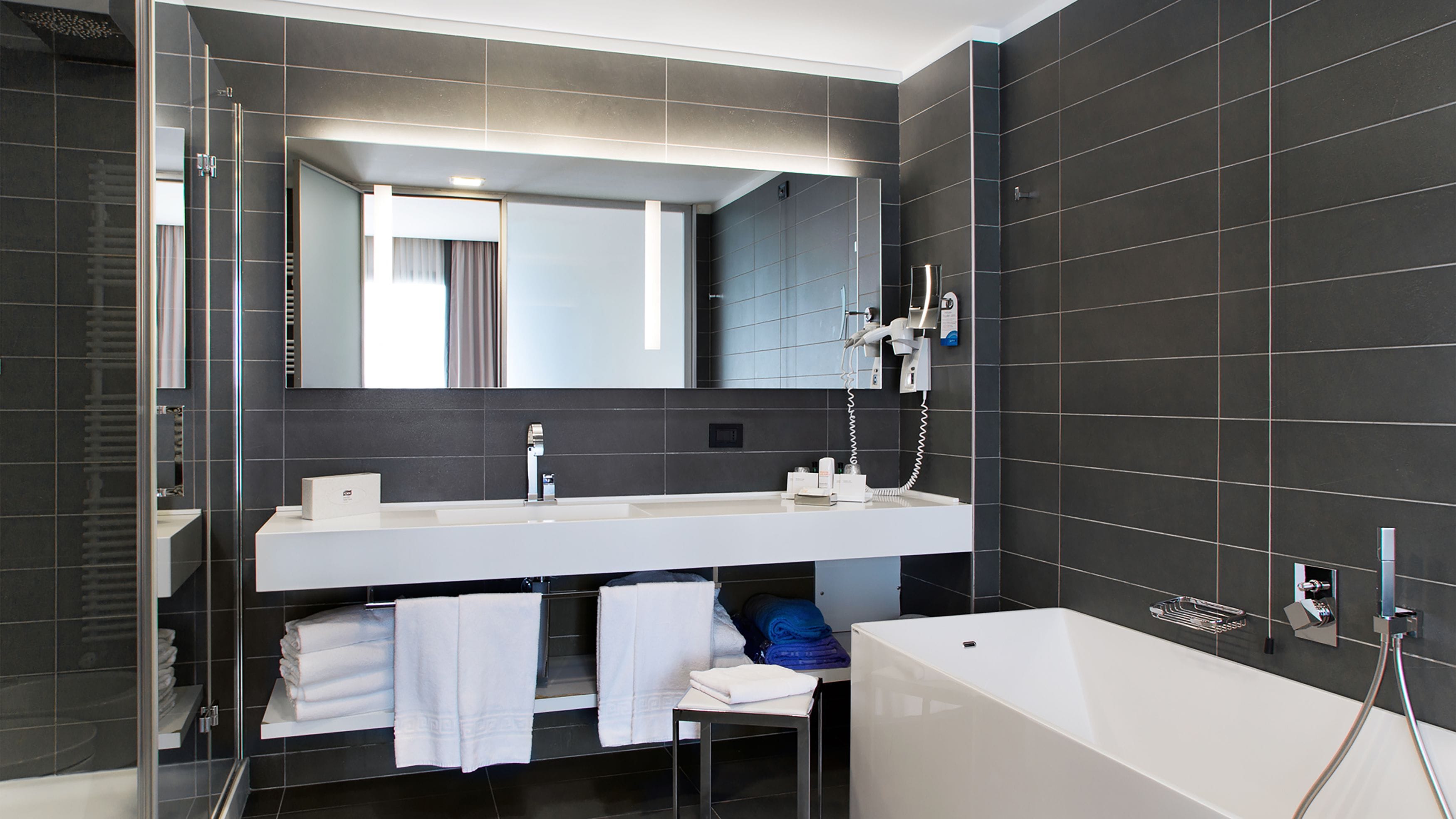 deep-soaking bathtub, rainfall showerhead, free toiletries, bathrobes