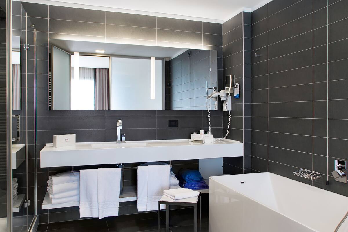 deep-soaking bathtub, rainfall showerhead, free toiletries, bathrobes