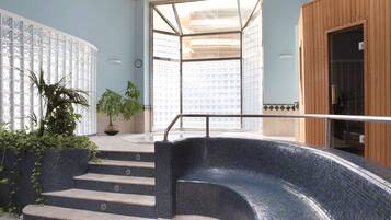 Relax by the pool surrounded by a mosaic-tiled edge and steps leading up to the water.