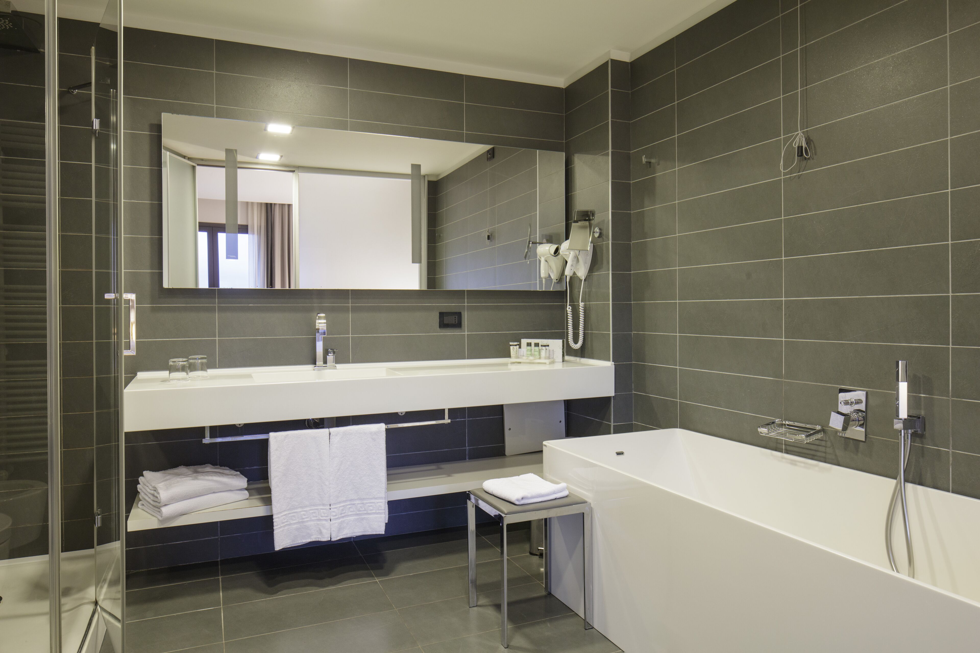 majestic junior suite | bathroom | deep-soaking bathtub, rainfall showerhead, free toiletries, bathrobes