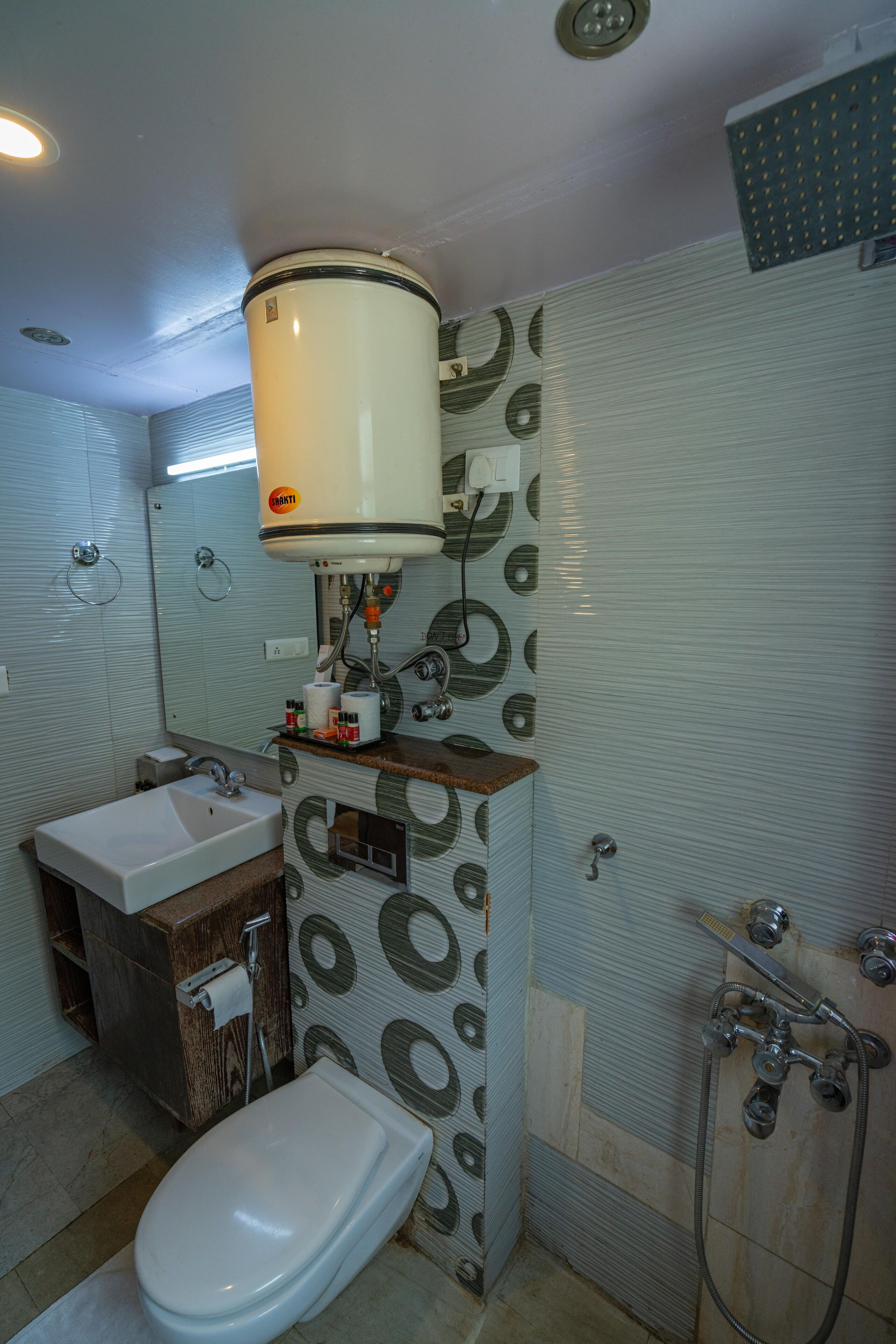 A bathroom with a toilet, sink, and shower.