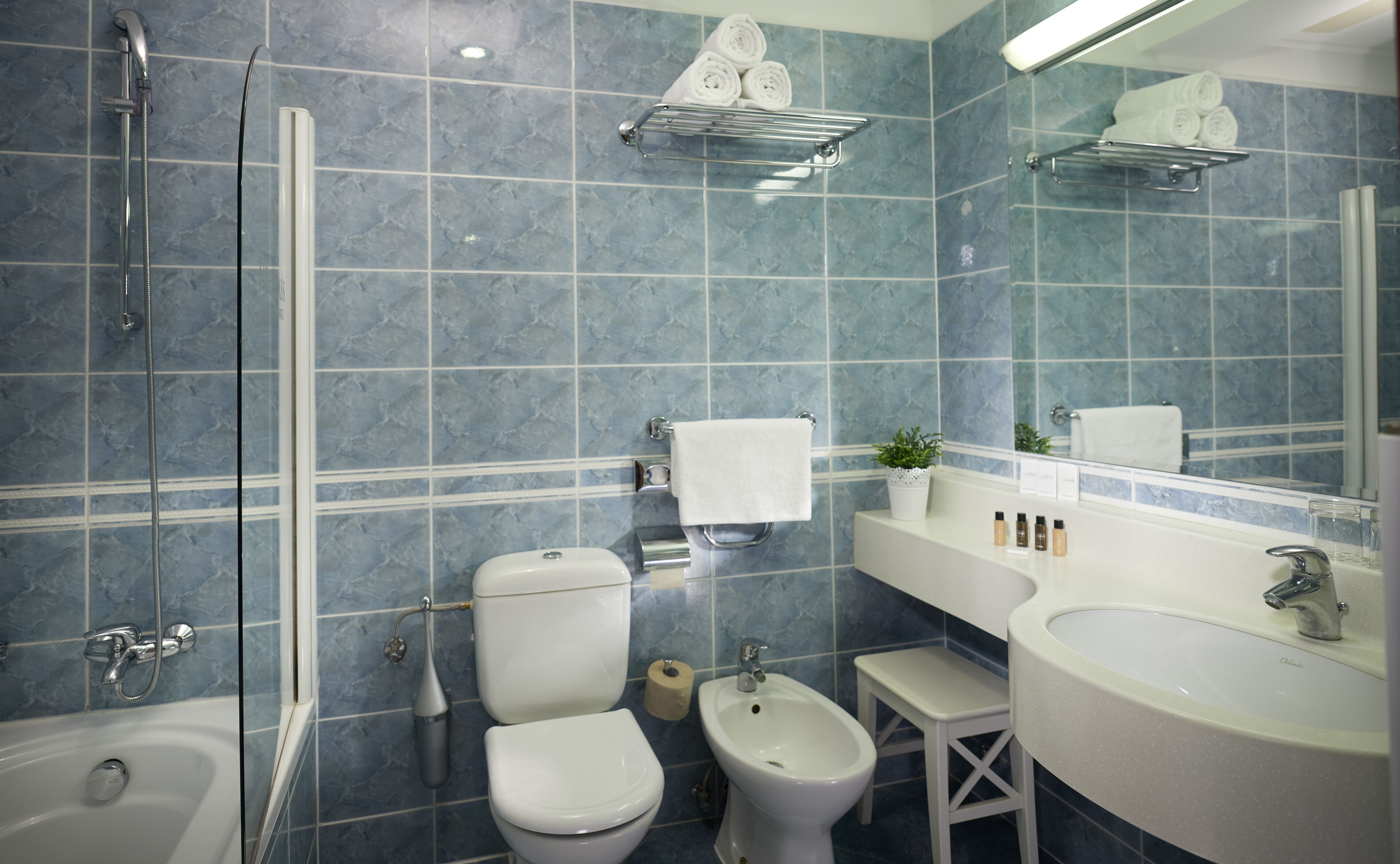 Un baño con bañera, inodoro, bidé y lavabo.