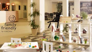 Enjoy family-friendly fun in this welcoming space with a play area, comfortable seating, and a touch of greenery.