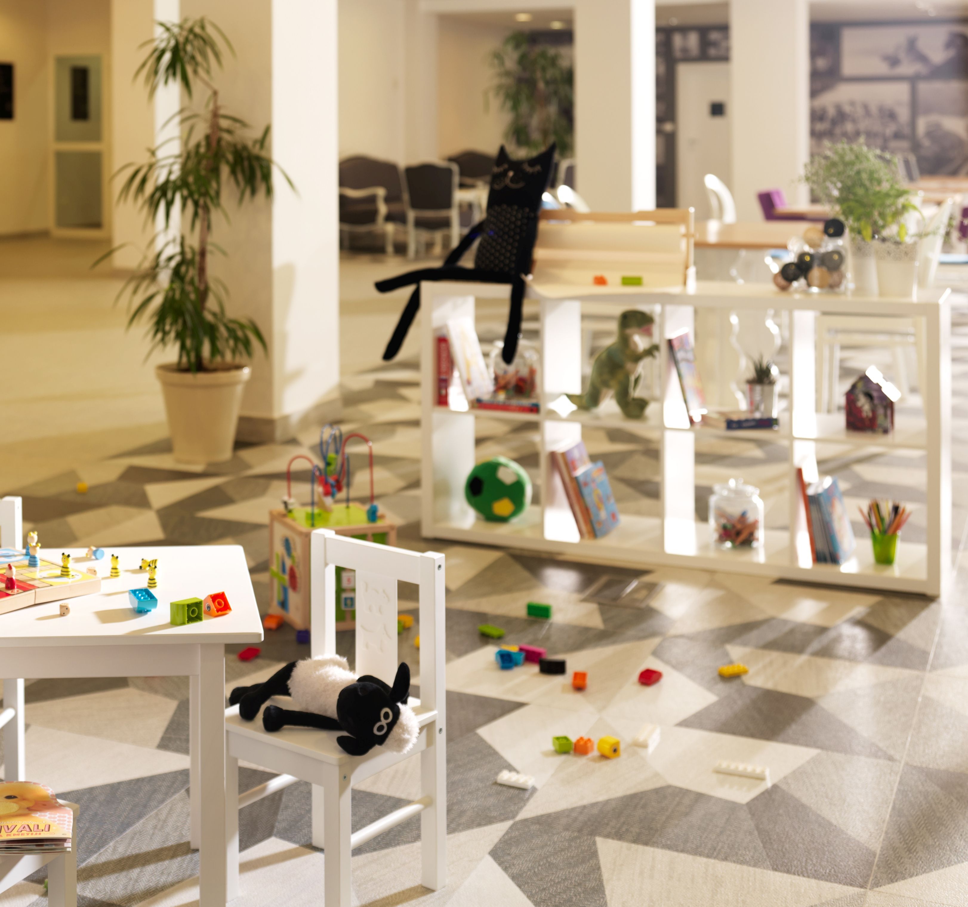 A children's play area with toys and a chair.