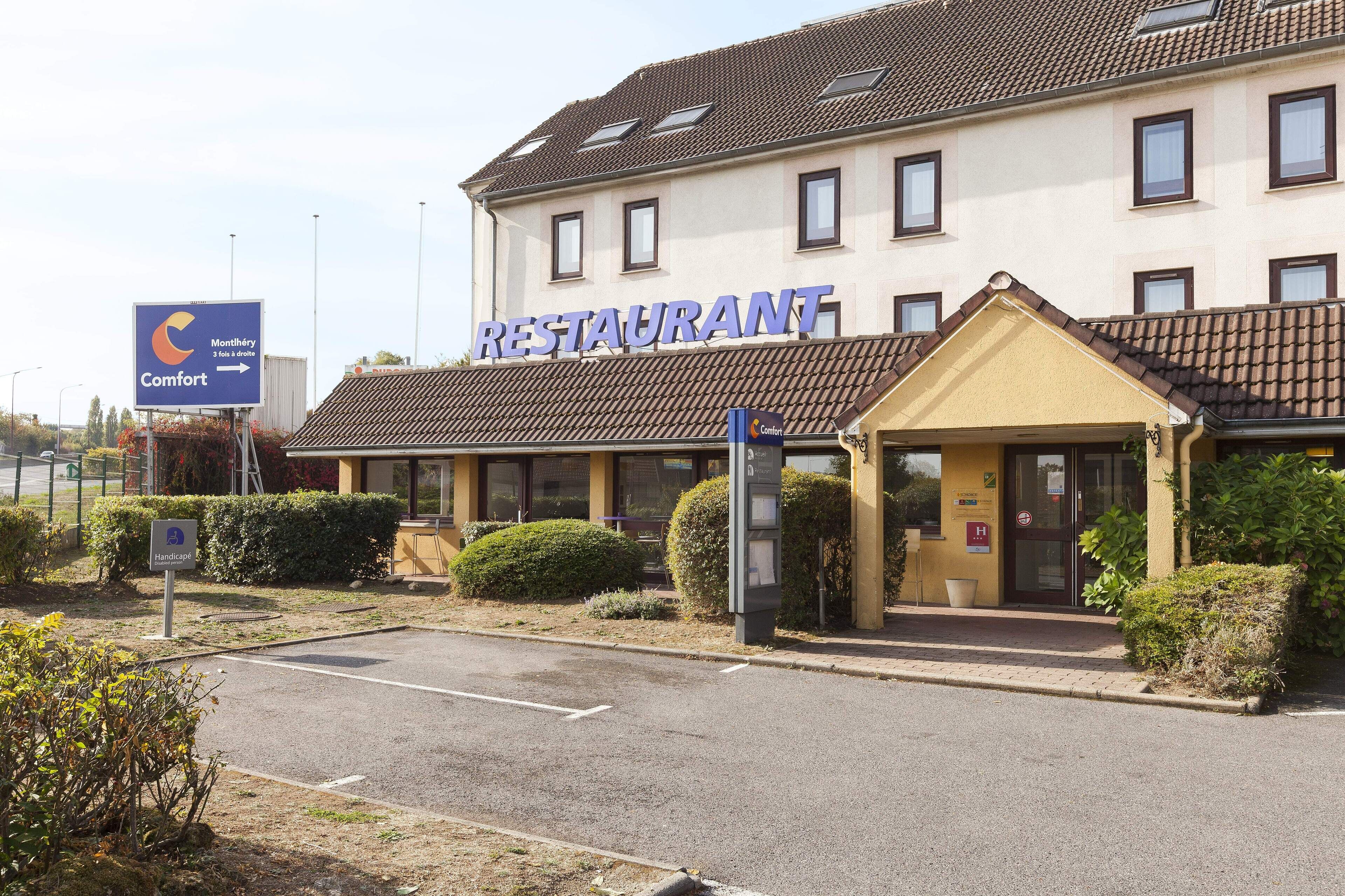 A building with a sign reading "RESTAURANT" and a smaller sign indicating "Comfort" and "Handicap" facilities.