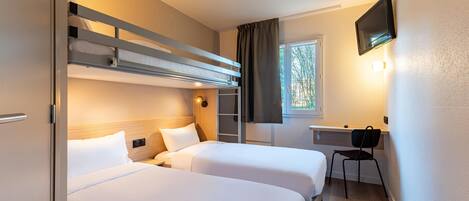 A hotel room with two beds, a desk, a chair, a TV, and a window with curtains.