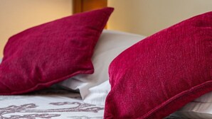 Una cama con dos almohadas y un edredón estampado.