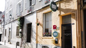 Un edificio con un letrero negro que dice "Logis Hotels" y el número "2" en la puerta.
