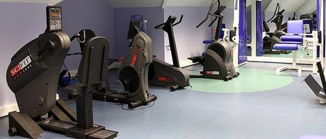 A gym with stationary bikes, treadmills, and exercise equipment.