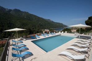 Seasonal outdoor pool, open 9 AM to 8 PM, pool umbrellas, pool loungers