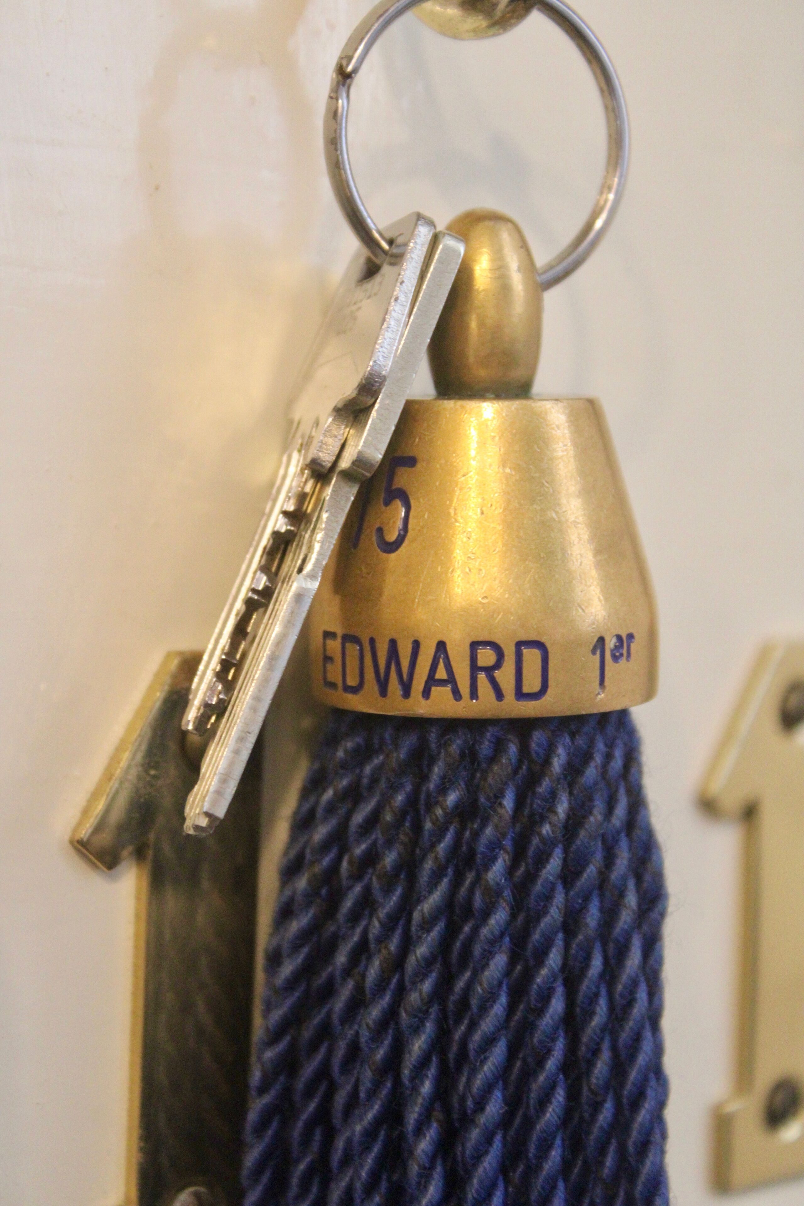 A brass keychain with a key attached, labeled "EDWARD 1st".