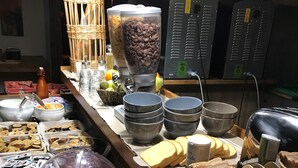 A buffet with various food items including meats, cheeses, and bread. - Kyriad - Narbonne Sud (Narbonne)