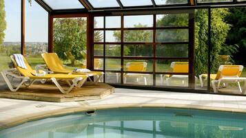 Indoor pool, open 9:00 AM to 9:30 PM, pool loungers