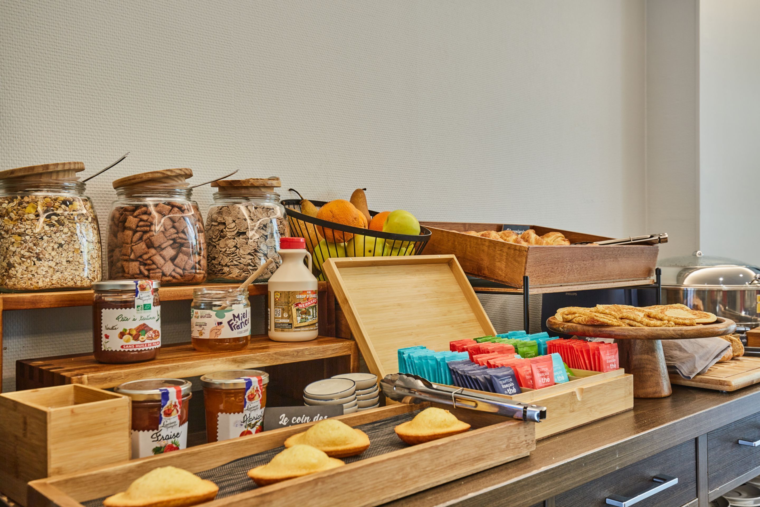 A buffet setup with various food items and condiments.