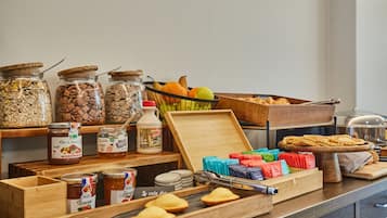 A buffet setup with various food items and condiments.
