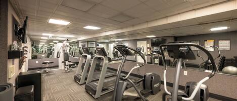A gym with treadmills, ellipticals, and exercise equipment.