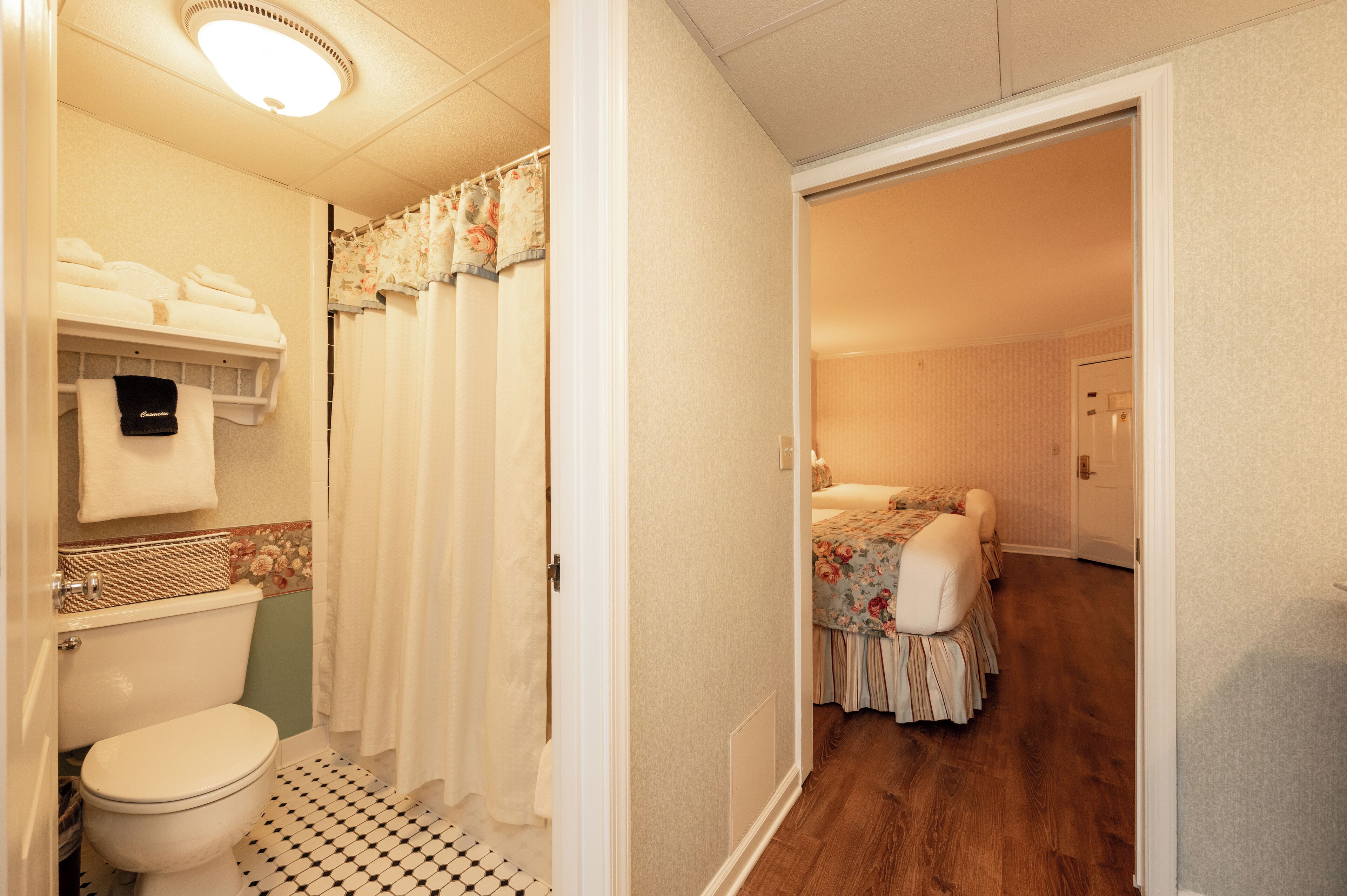 A bathroom with a toilet, a sink, and a shower curtain.