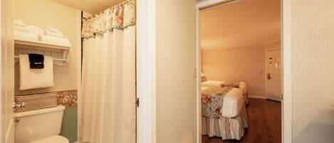 A bathroom with a toilet, a sink, and a shower curtain.