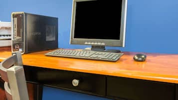 A computer desk with a desktop computer, keyboard, and mouse.