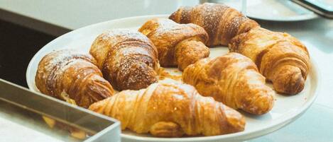 A plate of assorted croissants on a table.