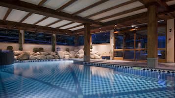 Relax by the pool surrounded by a seating area with a view.