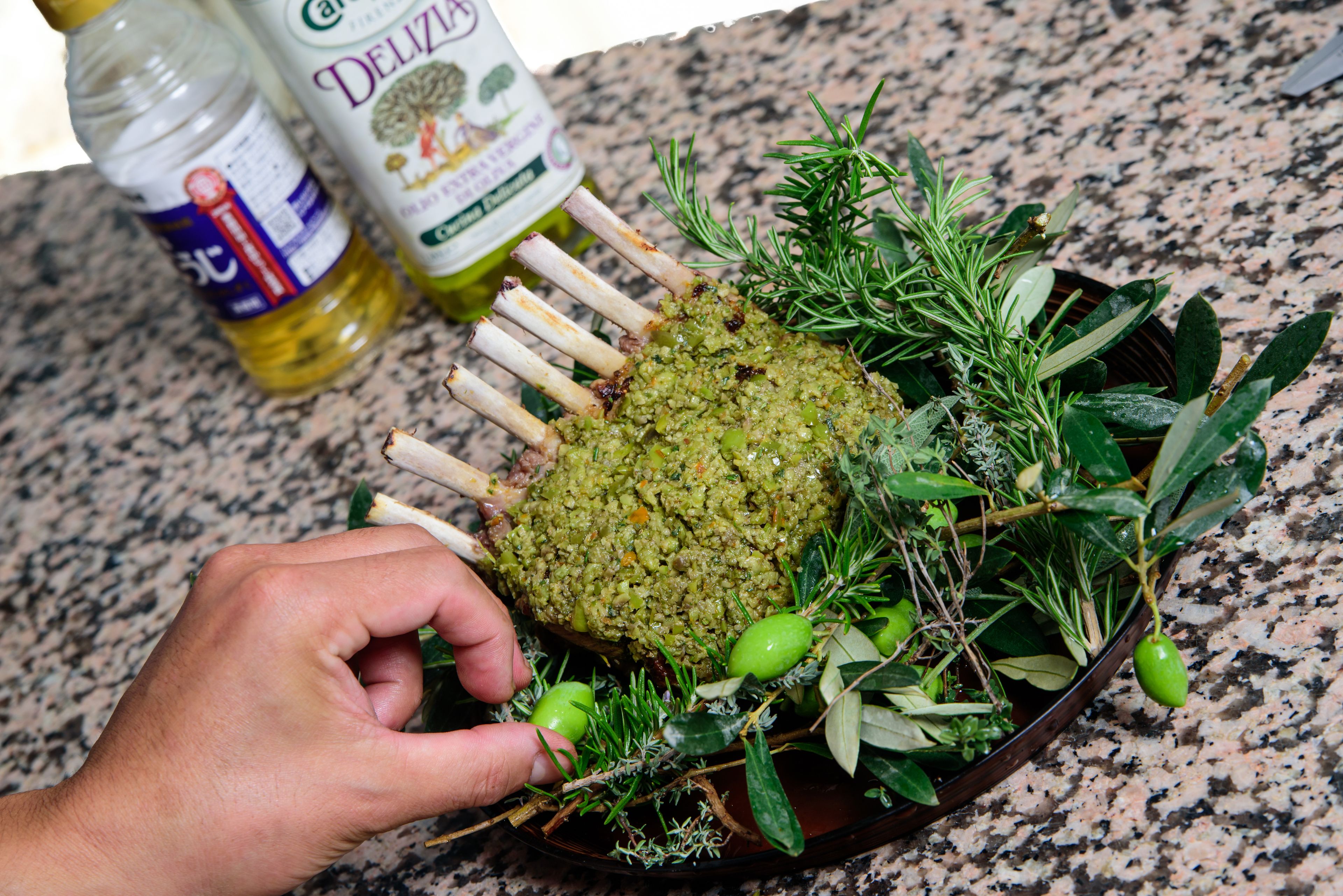 A dish with meat and herbs on a granite countertop.
