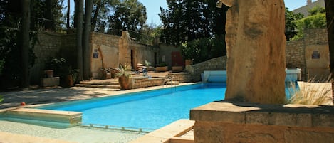 Seasonal outdoor pool, open 8:30 AM to 8:00 PM, pool loungers