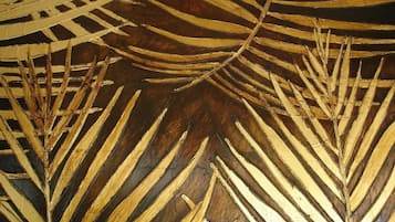 A close-up of a textured wall with a pattern resembling palm fronds.