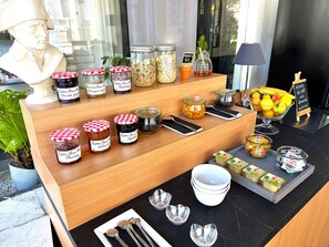 A breakfast buffet with various food items and condiments.