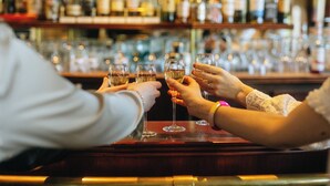 A bar with multiple bottles and glasses. - Hotel Ar Milin (Chateaubourg)