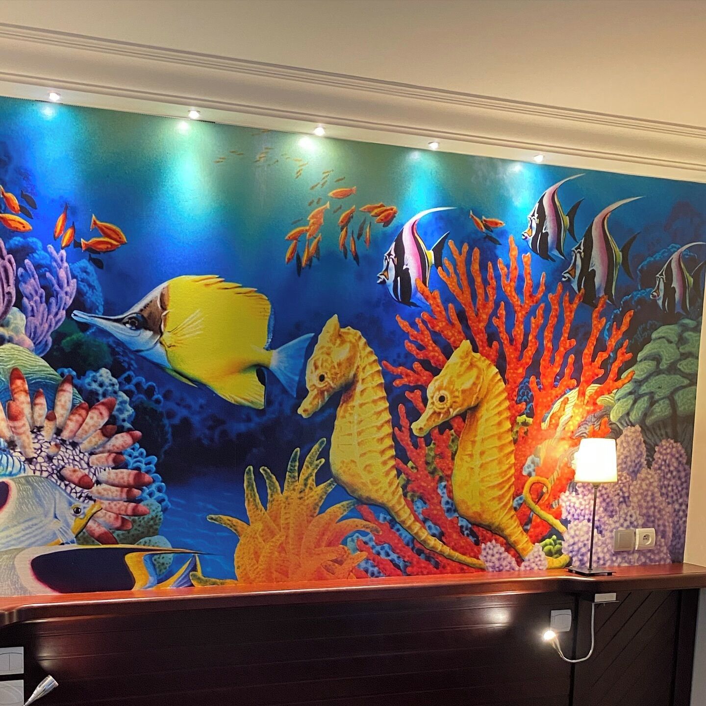 A vibrant underwater mural with fish and seahorses.
