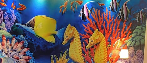 A vibrant underwater mural with fish and seahorses.