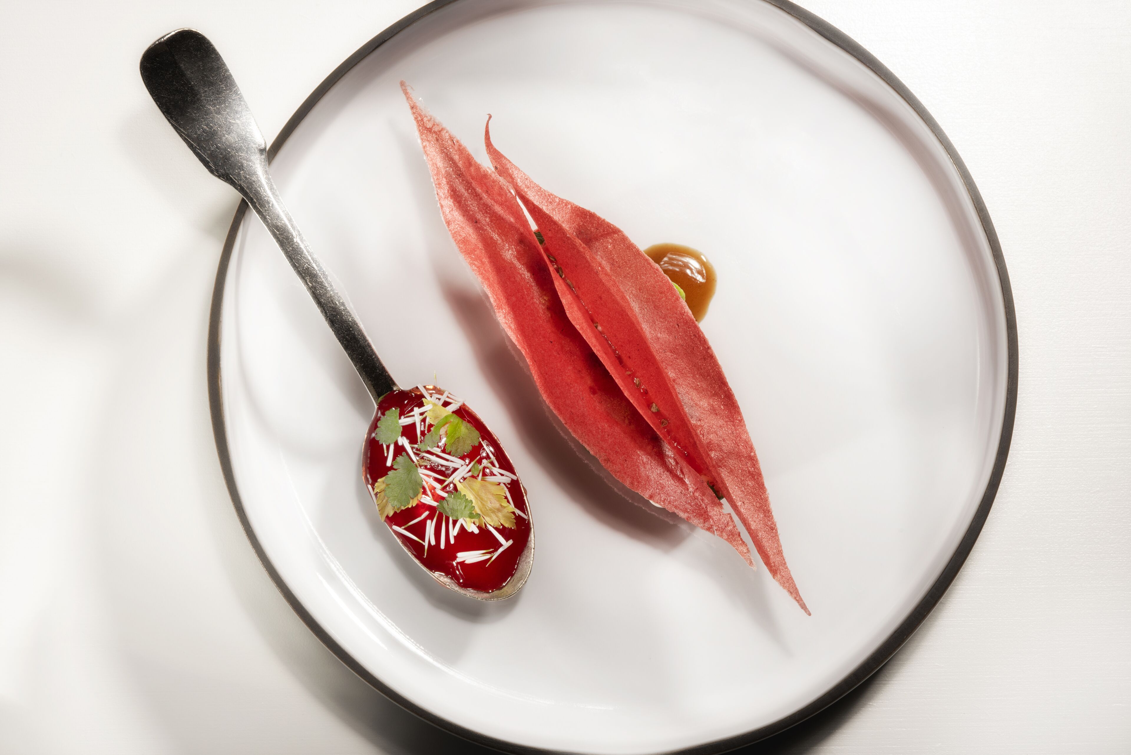 A white plate with a spoon and a piece of food.