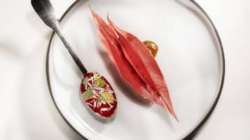 A white plate with a spoon and a piece of food.