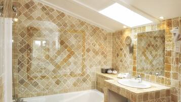 A bathroom with a bathtub, a sink, and a mirror.