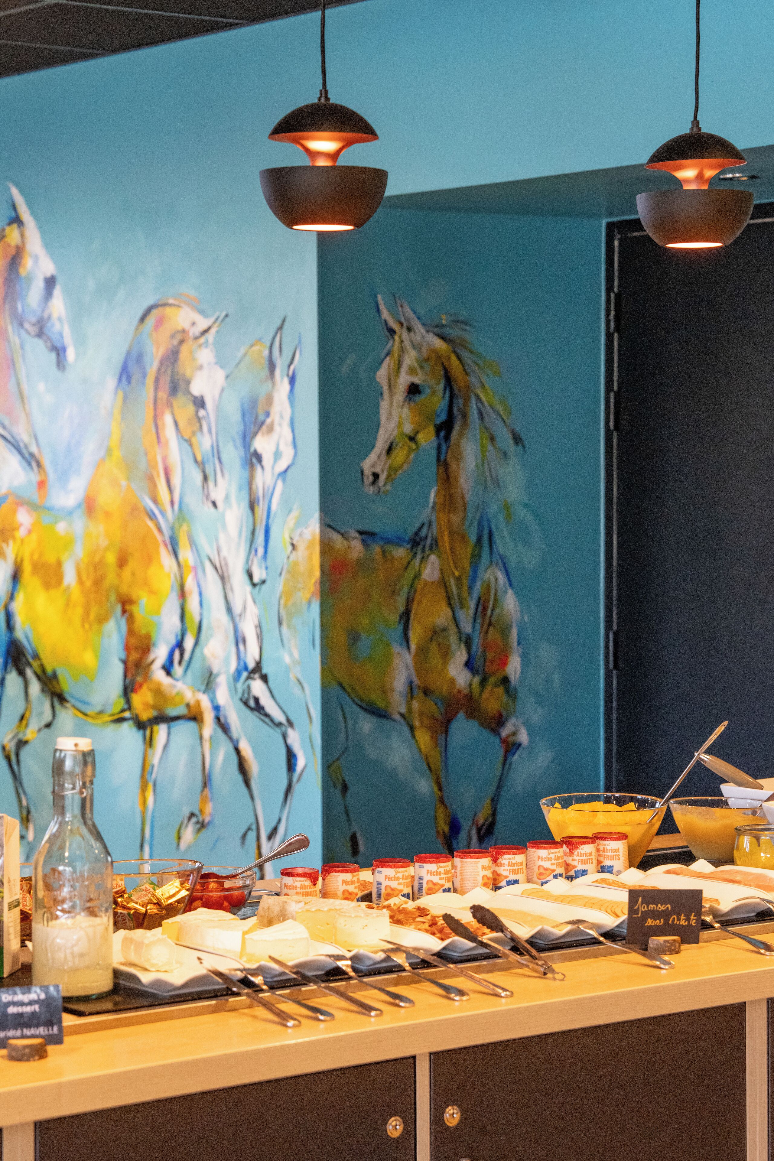 A buffet area with a mural of horses, a variety of food items, and a sign indicating 'Jammer's Room Not Available'.