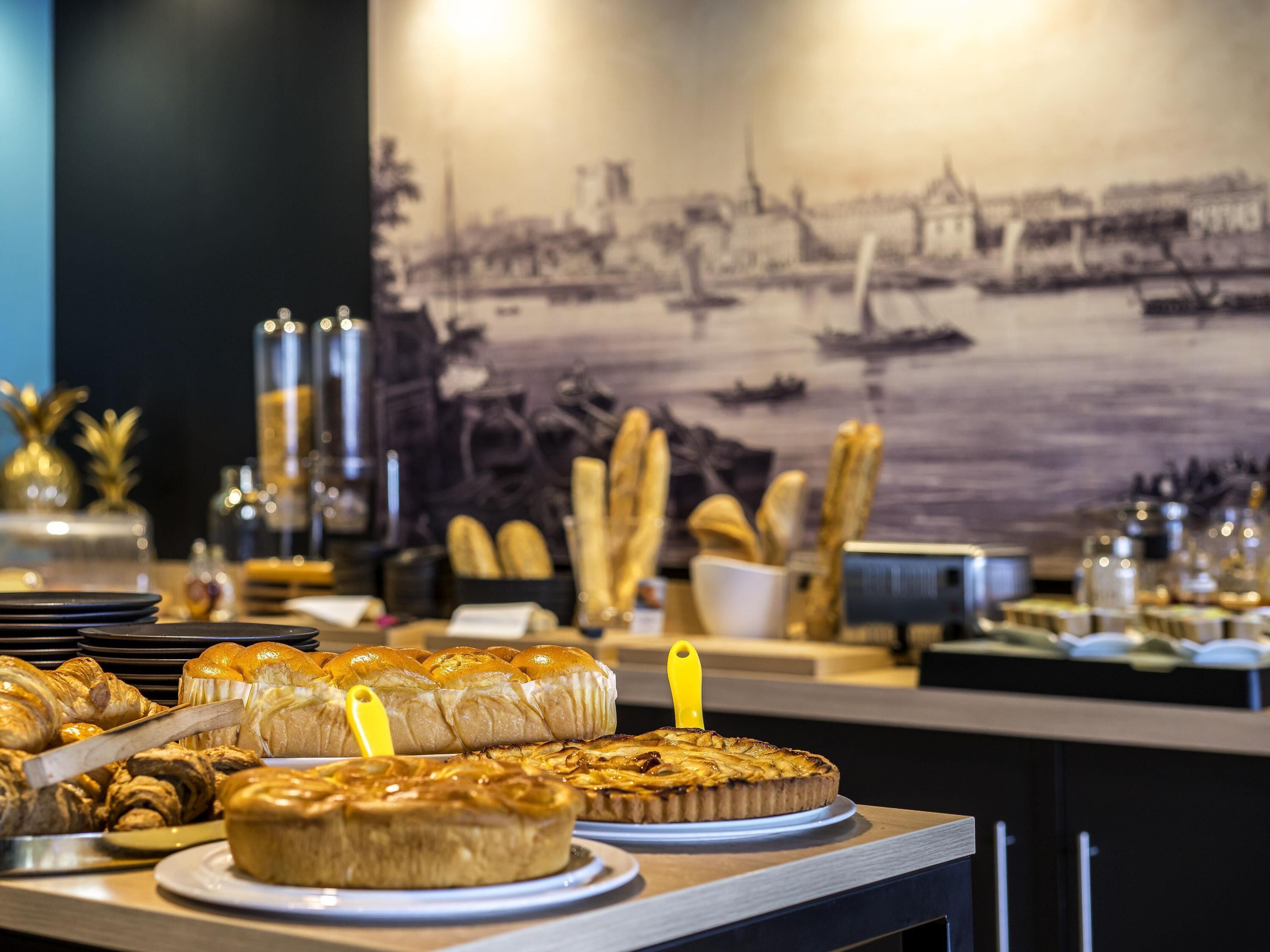A buffet table with various baked goods and pastries.