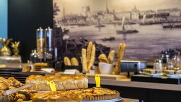 A buffet table with various baked goods and pastries.