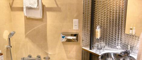 A modern bathroom with a bathtub, a sink, and a large mirror.