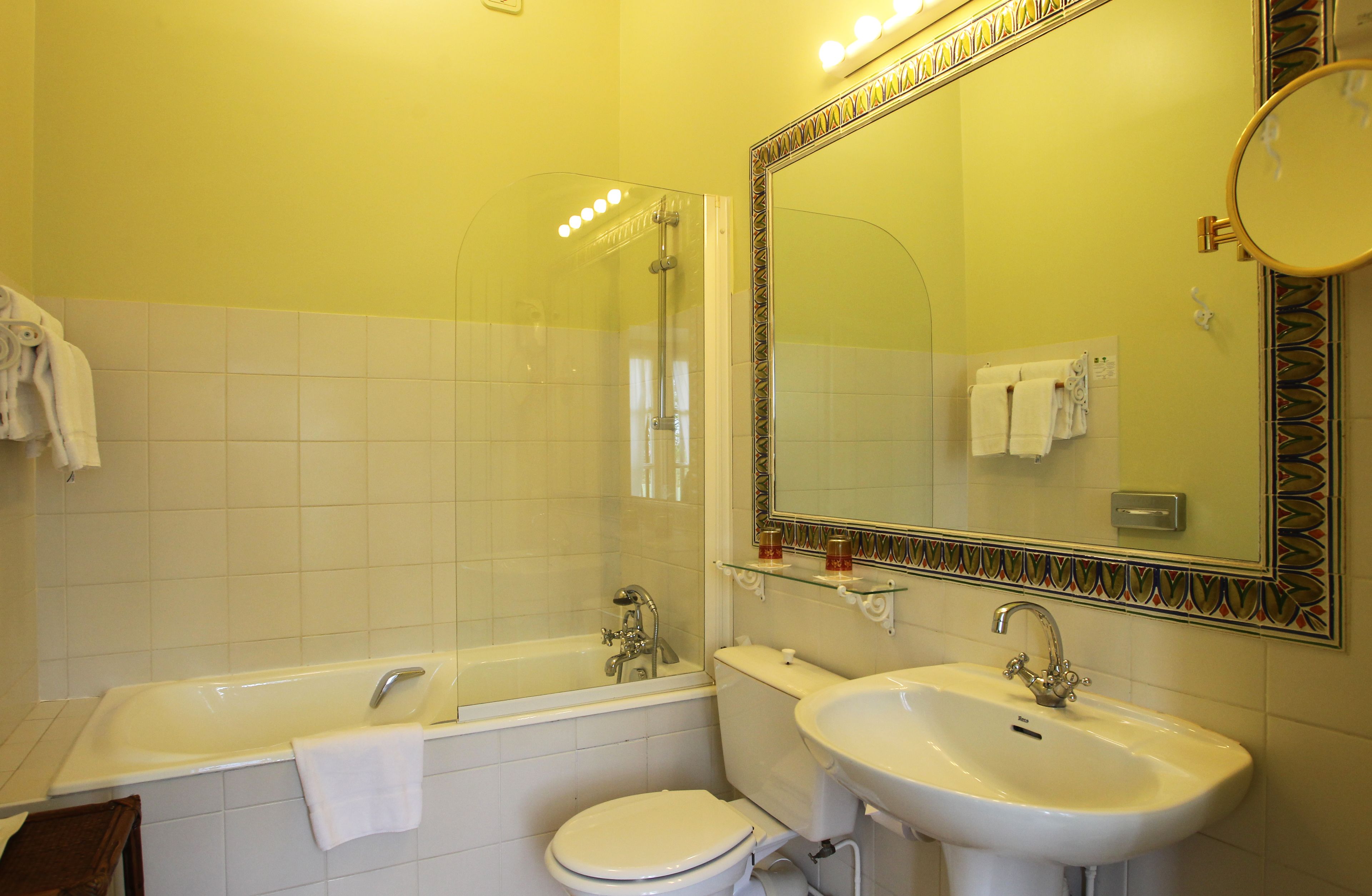 A bathroom with a bathtub, toilet, and sink.