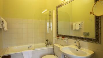 A bathroom with a bathtub, toilet, and sink.