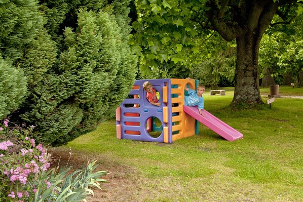 A playground with a slide and climbing structures in a park. - Parc Hotel (Wangenbourg-Engenthal)